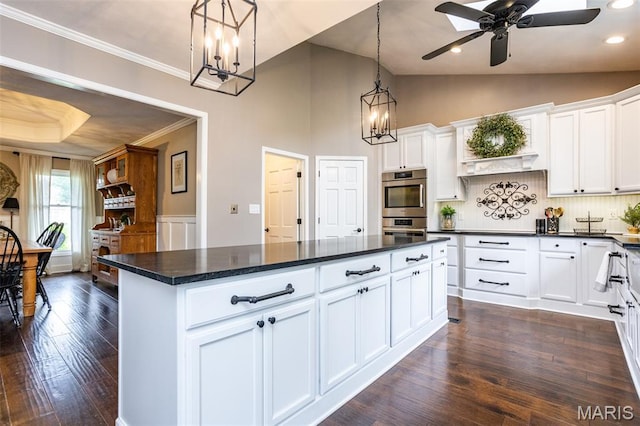 600 E Waters Edge Dr, Shiloh, IL 62221 - kitchen with dark countertops, a chandelier, backsplash, white cabinets, and crown molding