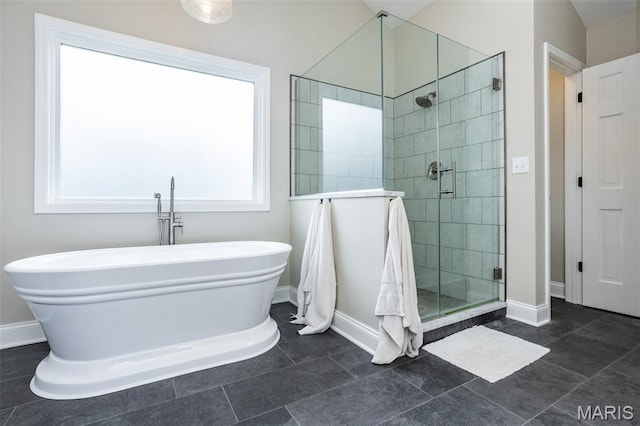 600 E Waters Edge Dr, Shiloh, IL 62221 - bathroom featuring baseboards, a freestanding bath, and a stall shower