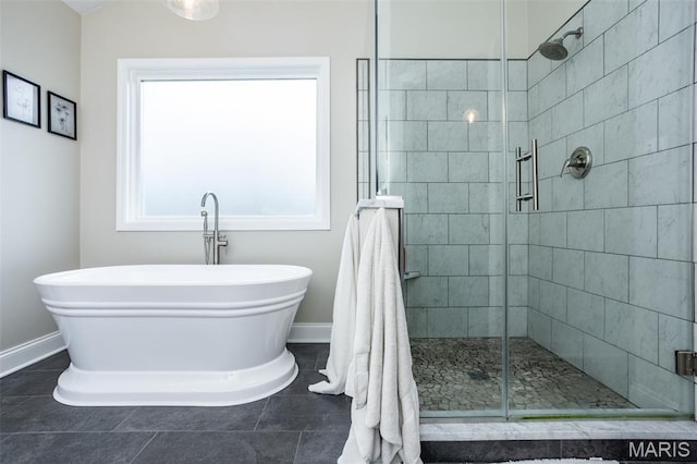 600 E Waters Edge Dr, Shiloh, IL 62221 - bathroom featuring baseboards, a freestanding tub, a stall shower, and tile patterned flooring
