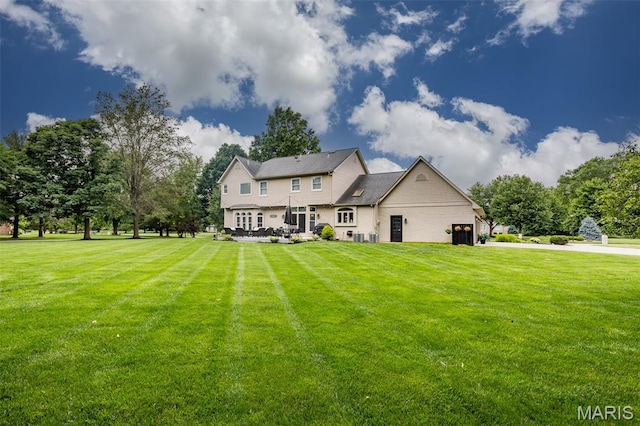 600 E Waters Edge Dr, Shiloh, IL 62221 - rear view of property with a lawn