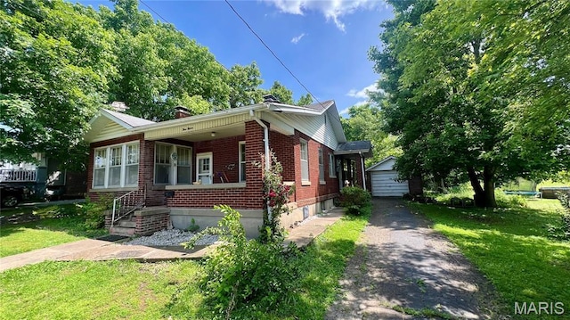 315 E College Ave, Fredericktown, MO 63645 - bungalow-style home with brick siding, a detached garage, an outdoor structure, driveway, and a front lawn