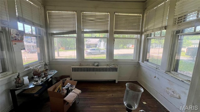 315 E College Ave, Fredericktown, MO 63645 - sunroom / solarium with radiator, plenty of natural light, and wood finished floors