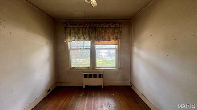 315 E College Ave, Fredericktown, MO 63645 - spare room with radiator heating unit, dark wood-style floors, and baseboards