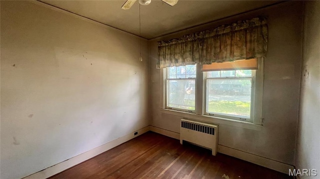 315 E College Ave, Fredericktown, MO 63645 - empty room featuring radiator, dark wood-type flooring, baseboards, and a ceiling fan