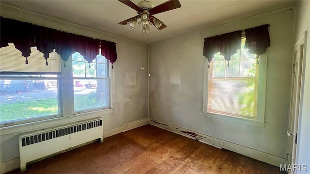 315 E College Ave, Fredericktown, MO 63645 - spare room featuring radiator heating unit, ceiling fan, and wood finished floors
