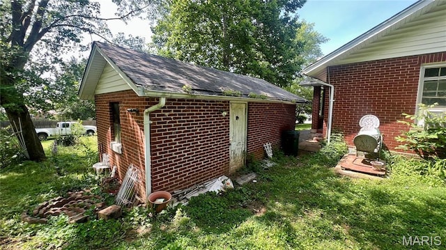 315 E College Ave, Fredericktown, MO 63645 - view of property exterior with brick siding, roof with shingles, and an outbuilding