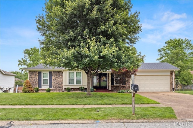 894 Napoli Dr, Ballwin, MO 63021 - view of front of home featuring a garage, brick siding, driveway, and a front yard