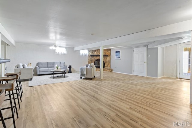 894 Napoli Dr, Ballwin, MO 63021 - living area featuring light wood-style flooring, a fireplace, and a chandelier