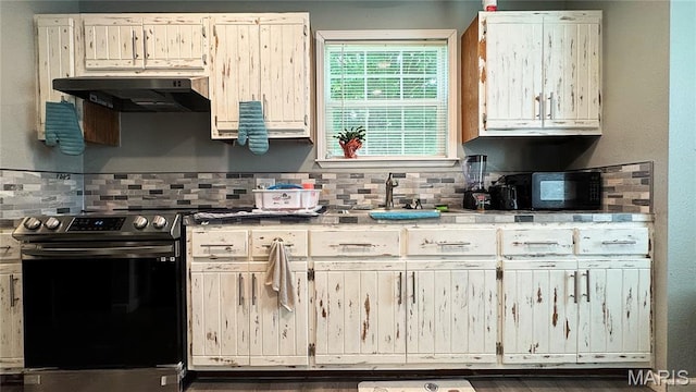 110 5th St, Park Hills, MO 63601 - kitchen with stainless steel range with electric stovetop, under cabinet range hood, a sink, decorative backsplash, and light countertops