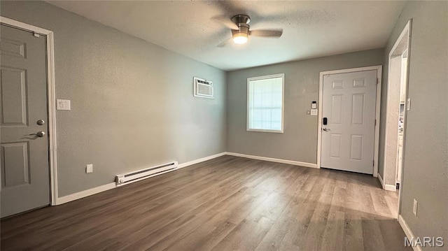 110 5th St, Park Hills, MO 63601 - foyer entrance with a baseboard radiator, wood finished floors, ceiling fan, a wall mounted air conditioner, and baseboards