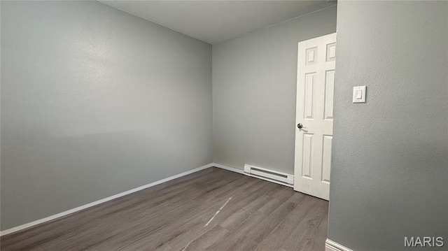 110 5th St, Park Hills, MO 63601 - empty room featuring a baseboard heating unit, wood finished floors, and baseboards