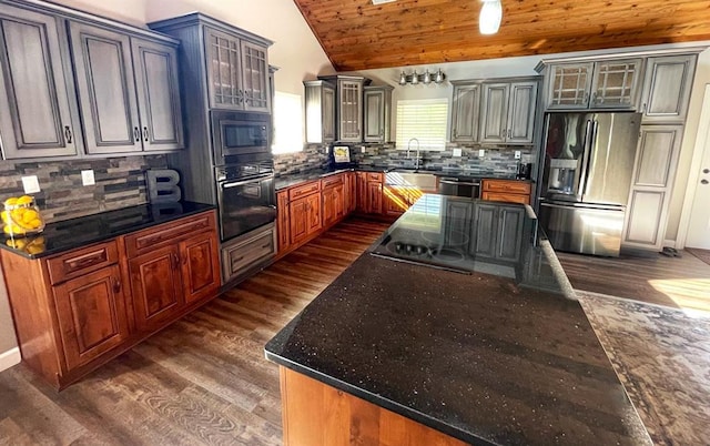 18428 Lake Circle Dr, Dexter, MO 63841 - kitchen with appliances with stainless steel finishes, dark wood-style floors, lofted ceiling, tasteful backsplash, and glass insert cabinets
