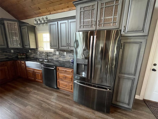 18428 Lake Circle Dr, Dexter, MO 63841 - kitchen featuring stainless steel fridge with ice dispenser, dishwasher, dark countertops, a sink, and vaulted ceiling