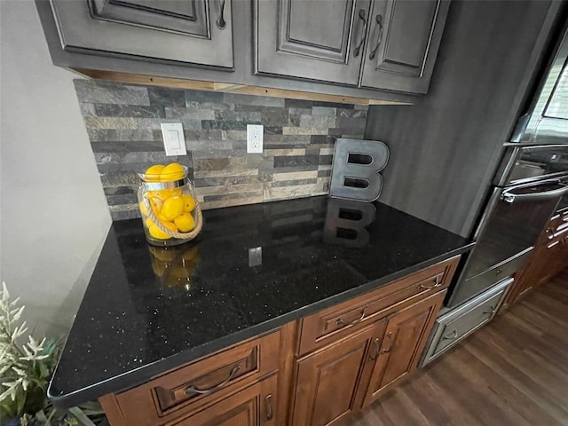 18428 Lake Circle Dr, Dexter, MO 63841 - kitchen with dark wood-style floors, decorative backsplash, and dark stone counters