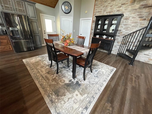 18428 Lake Circle Dr, Dexter, MO 63841 - dining space with dark wood-style floors, stairs, and high vaulted ceiling