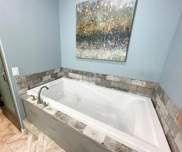 18428 Lake Circle Dr, Dexter, MO 63841 - bathroom with a tub with jets and stone tile flooring