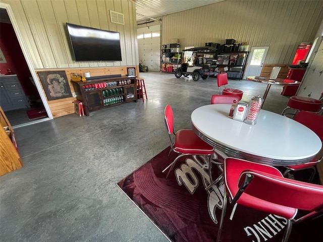 18428 Lake Circle Dr, Dexter, MO 63841 - dining room with concrete floors and wood walls