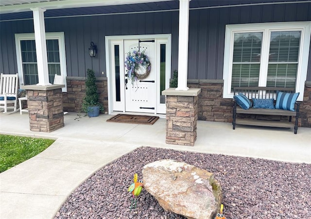 18428 Lake Circle Dr, Dexter, MO 63841 - property entrance featuring stone siding, board and batten siding, and covered porch
