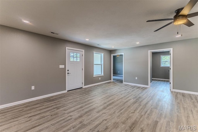 1223 Utah St, Lebanon, MO 65536 - unfurnished living room featuring light wood-type flooring, baseboards, a ceiling fan, and recessed lighting