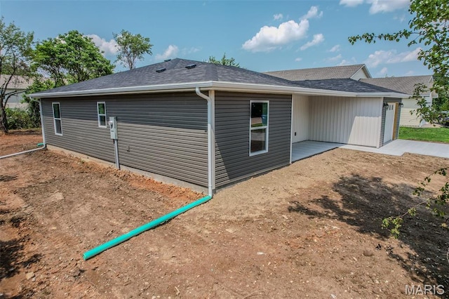 1223 Utah St, Lebanon, MO 65536 - view of side of home with a patio and roof with shingles