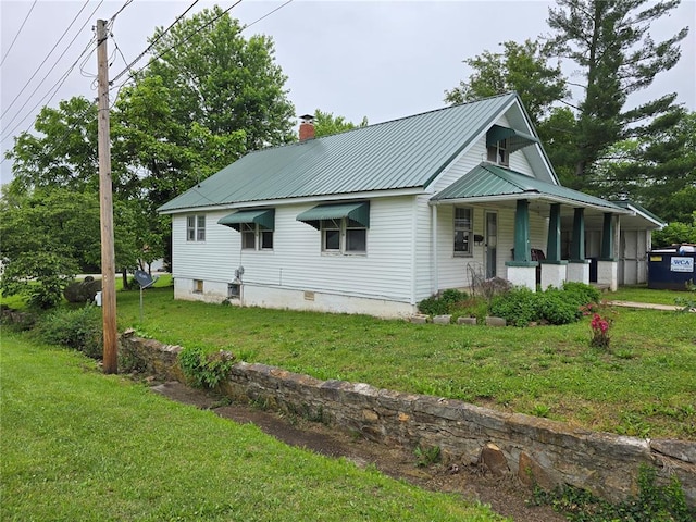 533 W Hawthorne St, Houston, MO 65483 - view of front of property with a porch, a front yard, a chimney, and metal roof