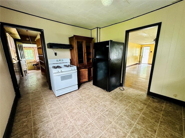 533 W Hawthorne St, Houston, MO 65483 - kitchen featuring gas range gas stove, freestanding refrigerator, extractor fan, and glass insert cabinets