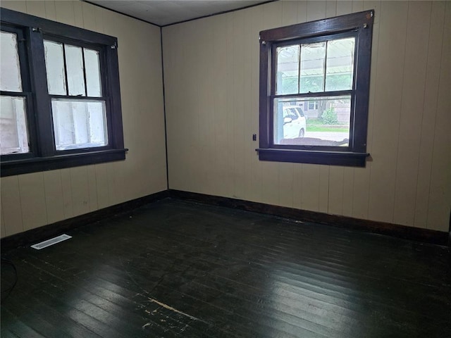 533 W Hawthorne St, Houston, MO 65483 - unfurnished room featuring hardwood / wood-style floors, baseboards, and wood walls