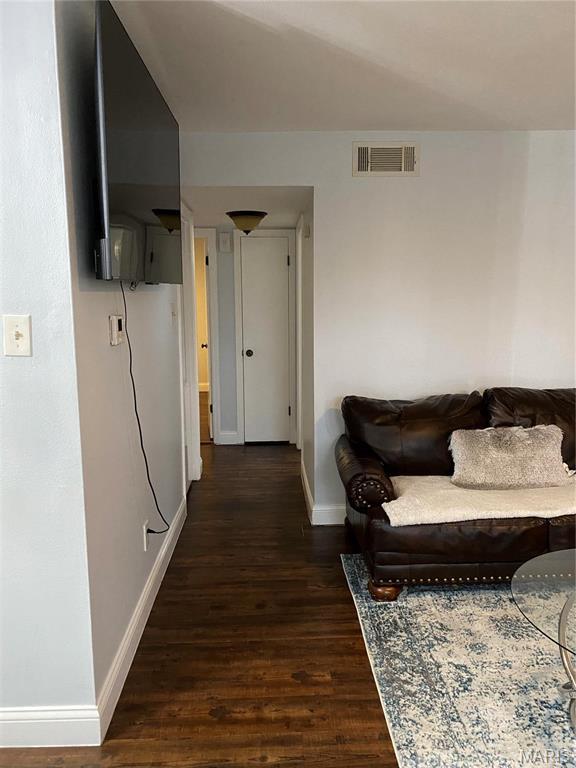 6966 Colonial Woods Dr Unit 62, Saint Louis, MO 63129 - living area with baseboards and wood finished floors