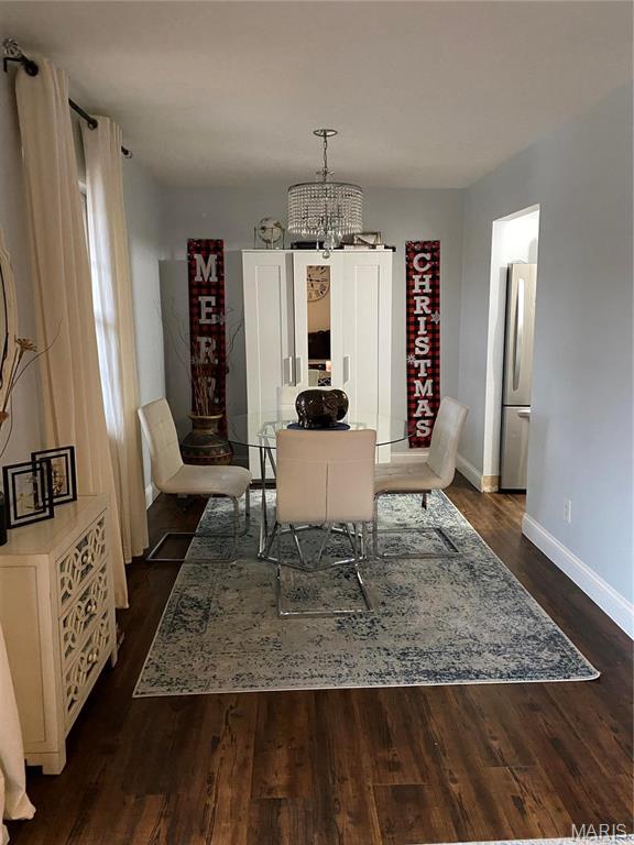 6966 Colonial Woods Dr Unit 62, Saint Louis, MO 63129 - dining area with baseboards, a chandelier, and dark wood-style flooring