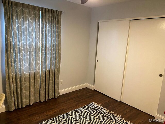 6966 Colonial Woods Dr Unit 62, Saint Louis, MO 63129 - unfurnished bedroom with wood finished floors, a closet, and baseboards
