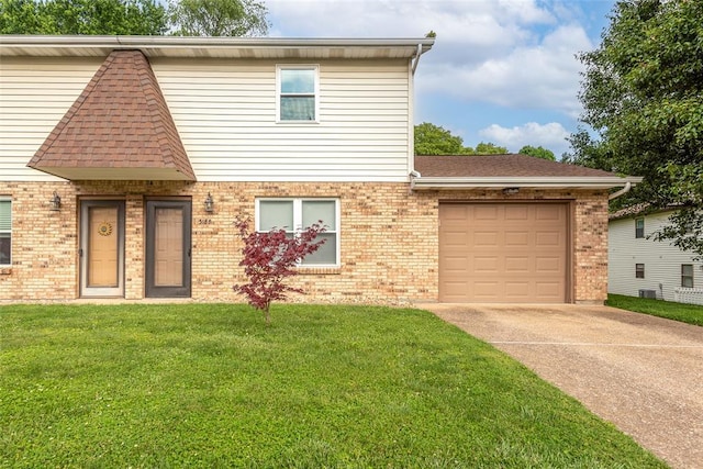 518 Bargraves Blvd Unit B, Troy, IL 62294 - view of front of home featuring brick siding, concrete driveway, an attached garage, a front lawn, and a shingled roof