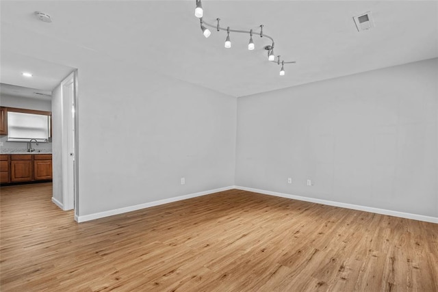 518 Bargraves Blvd Unit B, Troy, IL 62294 - spare room featuring light wood-style floors, baseboards, a smoke detector, and a sink