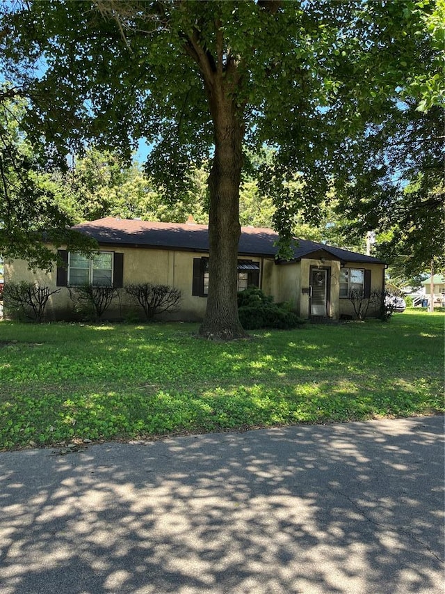 711 Lester St, Kennett, MO 63857 - view of front facade with stucco siding and a front lawn