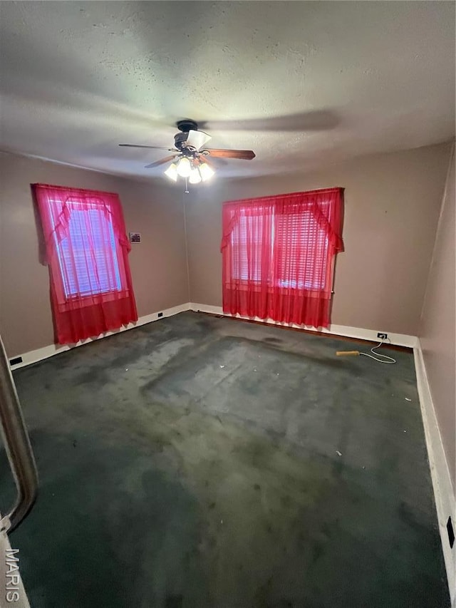 711 Lester St, Kennett, MO 63857 - carpeted spare room with baseboards and a ceiling fan