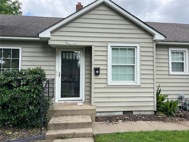 1904 E Parkview, Caruthersville, MO 63830 - doorway to property with a shingled roof and a chimney