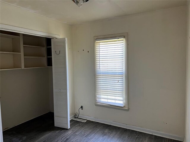 1904 E Parkview, Caruthersville, MO 63830 - unfurnished bedroom featuring dark wood-style floors, a closet, and baseboards