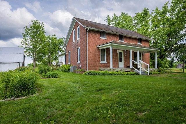 216 County Road 512, Shawneetown, MO 63732 - view of front of home with a porch, brick siding, and a front lawn
