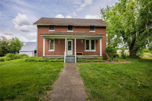 216 County Road 512, Shawneetown, MO 63732 - traditional home featuring a porch, a front lawn, and brick siding