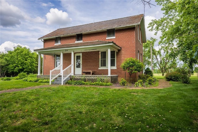 216 County Road 512, Shawneetown, MO 63732 - view of front of home with a porch, brick siding, and a front lawn