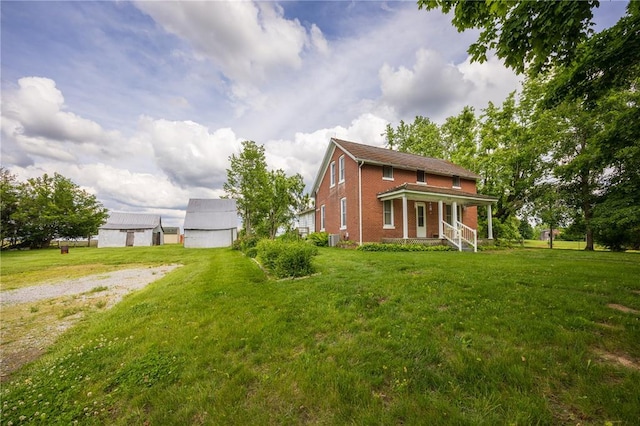 216 County Road 512, Shawneetown, MO 63732 - view of front facade with brick siding, a front lawn, and a porch