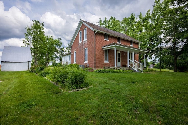216 County Road 512, Shawneetown, MO 63732 - view of front of house with brick siding, a porch, and a front yard