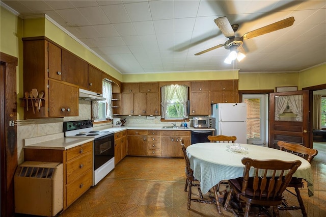 216 County Road 512, Shawneetown, MO 63732 - kitchen with white appliances, under cabinet range hood, ornamental molding, brown cabinets, and light countertops