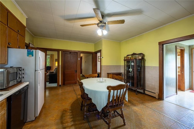 216 County Road 512, Shawneetown, MO 63732 - dining area with crown molding, a ceiling fan, a wainscoted wall, and tile patterned floors