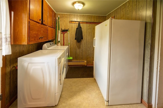 216 County Road 512, Shawneetown, MO 63732 - laundry area with independent washer and dryer, a baseboard radiator, wooden walls, and cabinet space