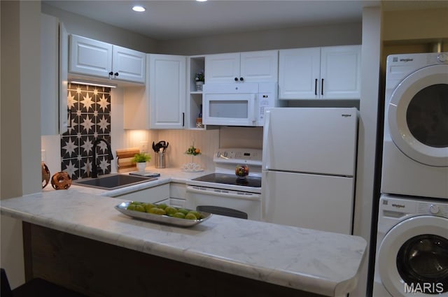 115 Lemans Ct Unit 115, Lake St Louis, MO 63367 - kitchen featuring white appliances, a sink, stacked washer / drying machine, light countertops, and white cabinetry