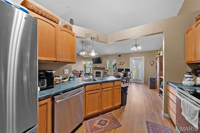 81 Berretta Ct, Wright City, MO 63390 - kitchen with appliances with stainless steel finishes, a sink, dark countertops, and light wood-type flooring