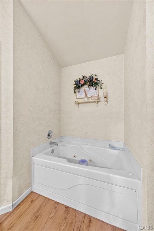 81 Berretta Ct, Wright City, MO 63390 - full bathroom with wood finished floors, a jetted tub, and vaulted ceiling