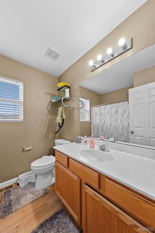 81 Berretta Ct, Wright City, MO 63390 - bathroom featuring vanity, toilet, wood finished floors, and a shower with shower curtain