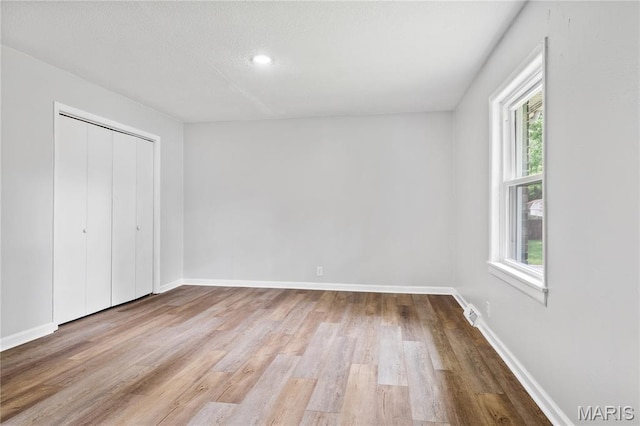 101 Green Acres St, Cape Girardeau, MO 63701 - unfurnished bedroom featuring wood finished floors, baseboards, and a closet