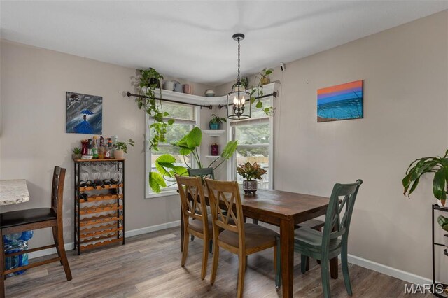 248 Prairie Grass Rd, Chatham, IL 62629 - dining room featuring a chandelier, wood finished floors, and baseboards